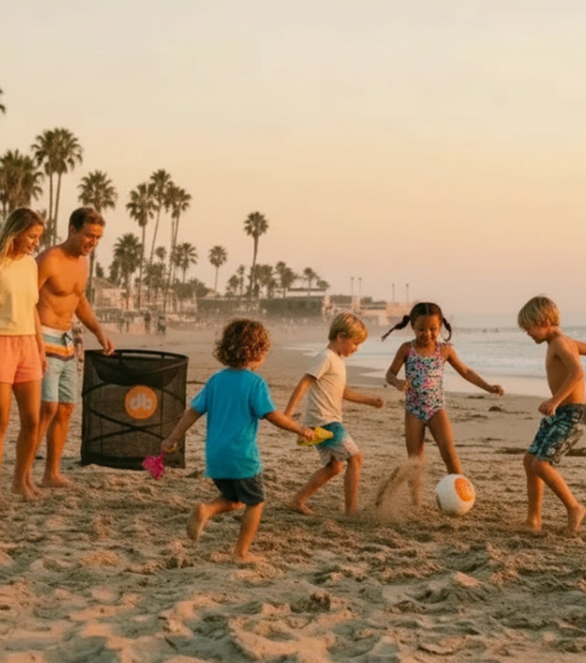 Family playing RoundBol on the beach at sunset